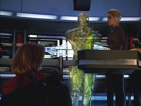 První se snaží vylepšit systémy Voyageru, aby se Borgům ubránil, je ale limitován jeho technologickou úrovní. Musí se transportovat na kouli, aby Voyager zachránil.
