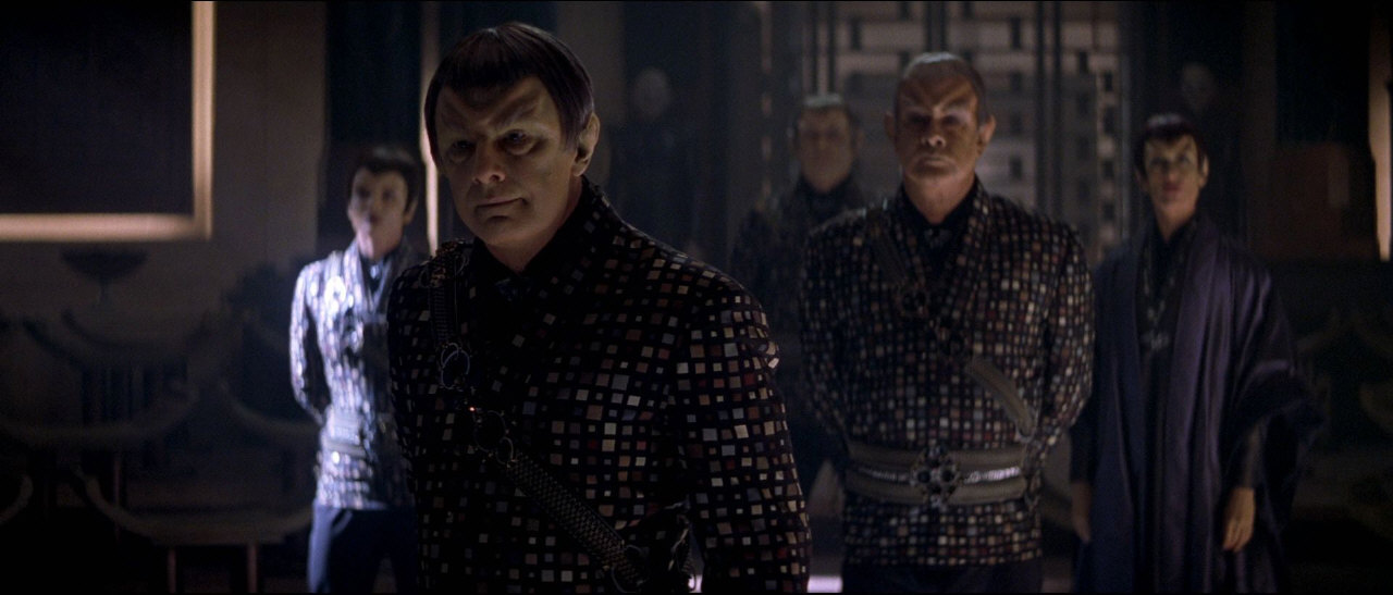 Mezitím na Romulu dochází přívržencům Shinzona z řad Romulanů trpělivost. Shinzon je důrazně odkáže do patřičných mezí a jednoho komandéra - Donatru - požádá, aby ho informovala o jakémkoli zrádném chování.