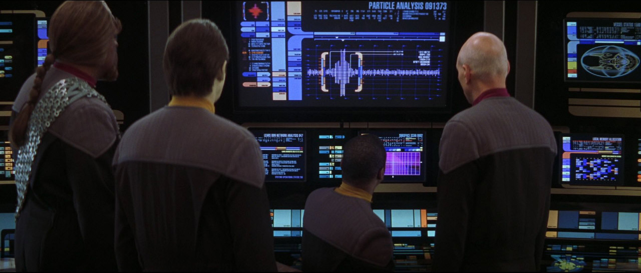 Zpátky na Enterprise se Picard dozvídá znepokojivé zprávy. Byl zaznamenán neautorizovaný přístup k hlavnímu počítači a senzory zaznamenaly přítomnost thalaronových částic, když se odmaskoval Scimitar.