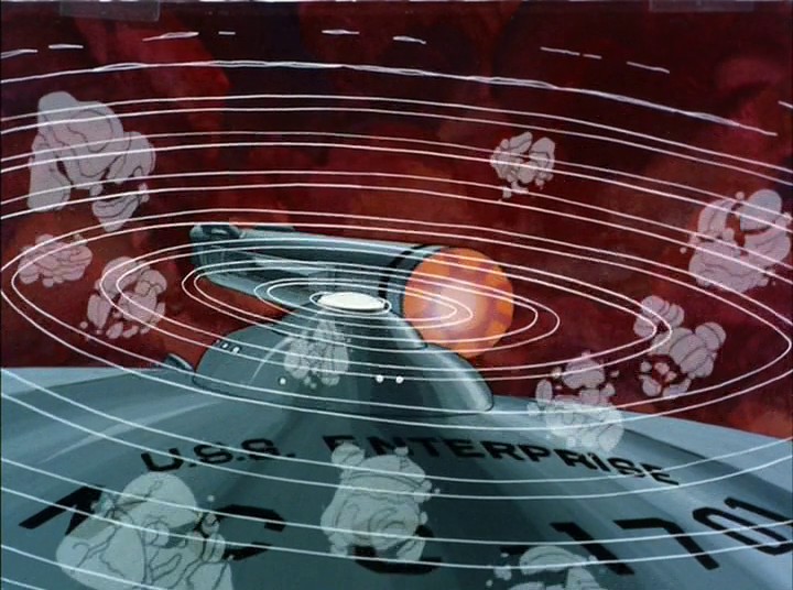 Enterprise je celá obklopena a napadají ji nějaké objekty. Kapitán nařizuje bránit se antihmotovými střelami, což se daří.