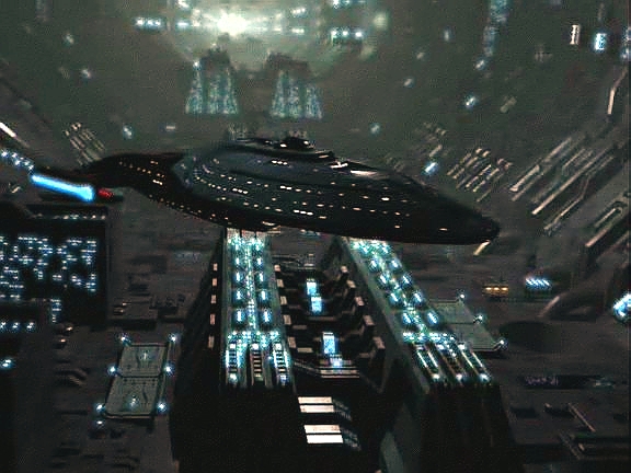 Vothové ale zatím Voyager transportovali do hangáru městské lodi. Posádka je proti velice vyspělé technologii tohoto prastarého druhu bezmocná.