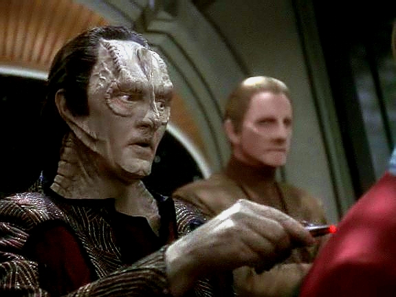 Sisko nemůže varovat Cardassiany přímo, Klingoni jsou stále spojenci. Pozve Garaka, aby mu vzal míry na oblek, a nepřímo ho informuje o velmi blízké hrozbě pro jeho vlast.
