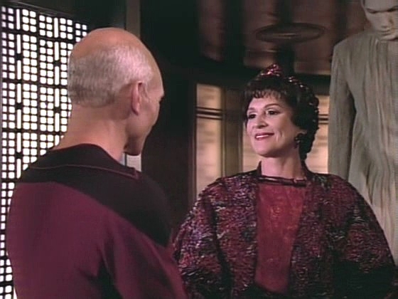 Kapitán Picard se poprvé setkává s Deanninou matkou Lwaxanou Troi. V pozadí sluha paní Troi, pan Homn.