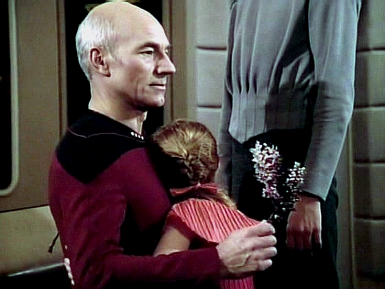 Zkoprnělý kapitán Picard přijímá díky malé Alexandry za to, že je dokázal vrátit na loď k rodičům.